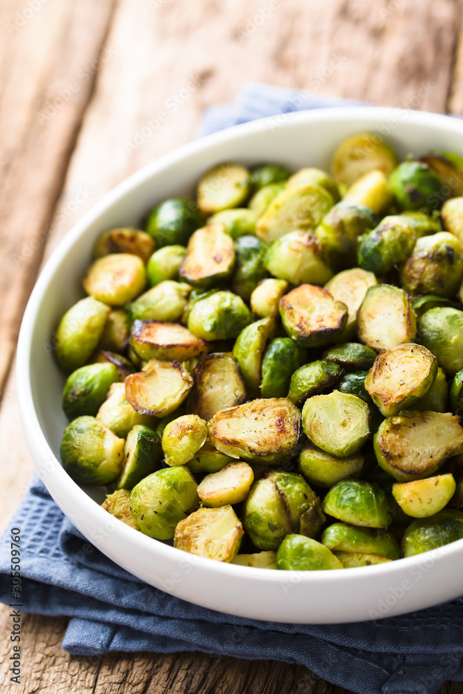 Fresh homemade roasted Brussels sprouts in white bowl (Selective Focus, Focus one third into the bowl) Fresh homemade roasted Brussels sprouts in white bowl (Selective Focus, Focus one third into the bowl)