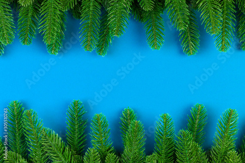 Top view of colorful festive background made of fir tree branch. Christmas holiday concept with copy space