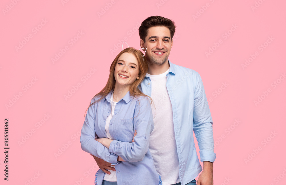 Young couple hugging and smiling for camera Young couple hugging and smiling for camera
