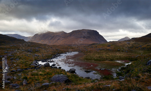 The summits of Beinn Dearg and Stuc Loch na Cabhaig with Lochan a Choire Dhuibh in the ofreground on an overcast winters day near Torridon in the North West Highlands of Scotland.