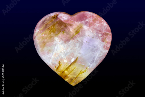 Carneol Agate Carved Heart Polished gem on  background. Macro shot.  photo