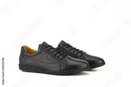 Black leather sneakers isolated on white background.