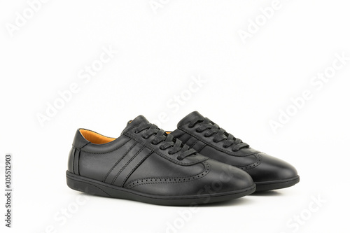 Black leather sneakers isolated on white background.