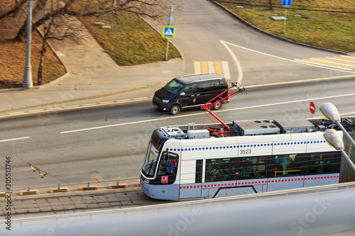 Blurred stripes and tracing from headlights. Electric train in motion. electric multiple unit. High speed  train in motion on railway station at sunset. Modern intercity passenger train with blur way photo