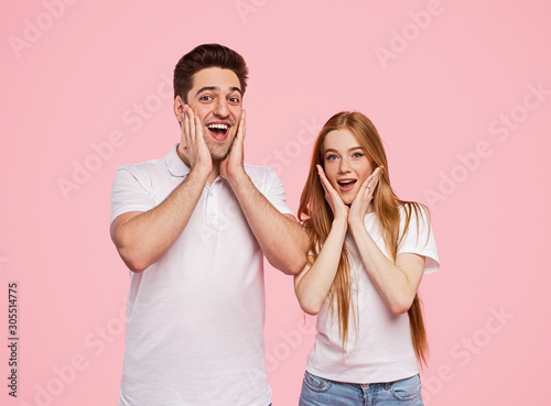 Excited man and woman looking at camera