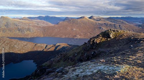 Views of Lochan Fada, Loch Garbhaig and the summit of Beinn Tarsuinn & Mullach Coire Mhic Fhearchair from the summit of Slioch in the Scottish Highlands in winter.