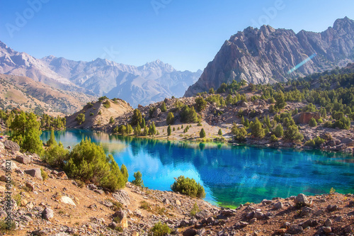 Obraz na płótnie Scenic mountains nature landscape with blue lake on sunny day. Beautiful view on turquoise water on mountain valley. Alaudin lake in Fann mountains, Tajikistan w salonie