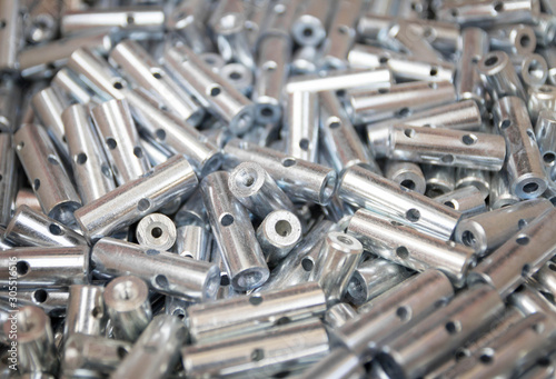 Steel sleeve. Details made lathe. Obtained on a lathe from steel and cast iron. Shallow depth of field. Parts stacked for further processing. Galvanized, coated part for anti-corrosion. Machined pipe