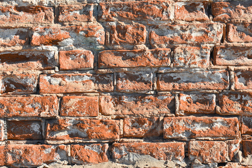 Background - old red brick wall with some ruined bricks  - very close view