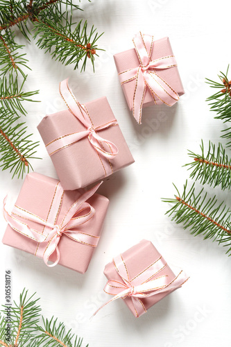 Christmas pink flat lay. Holiday boxes  fir branches on white background. Christmas winter holiday congratulation invitation birthday wedding.Long banner