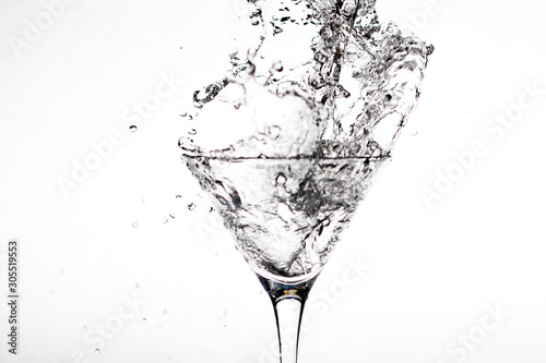 Black-white glass with champagne splashes on a white background