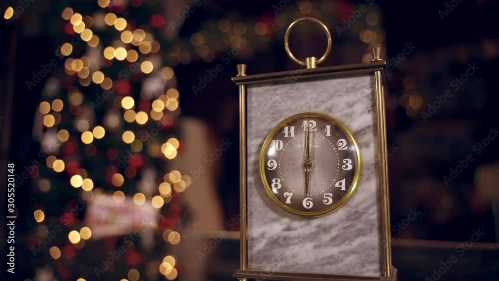 Golden clock on blur christmas background. Clock is showing six o'clock