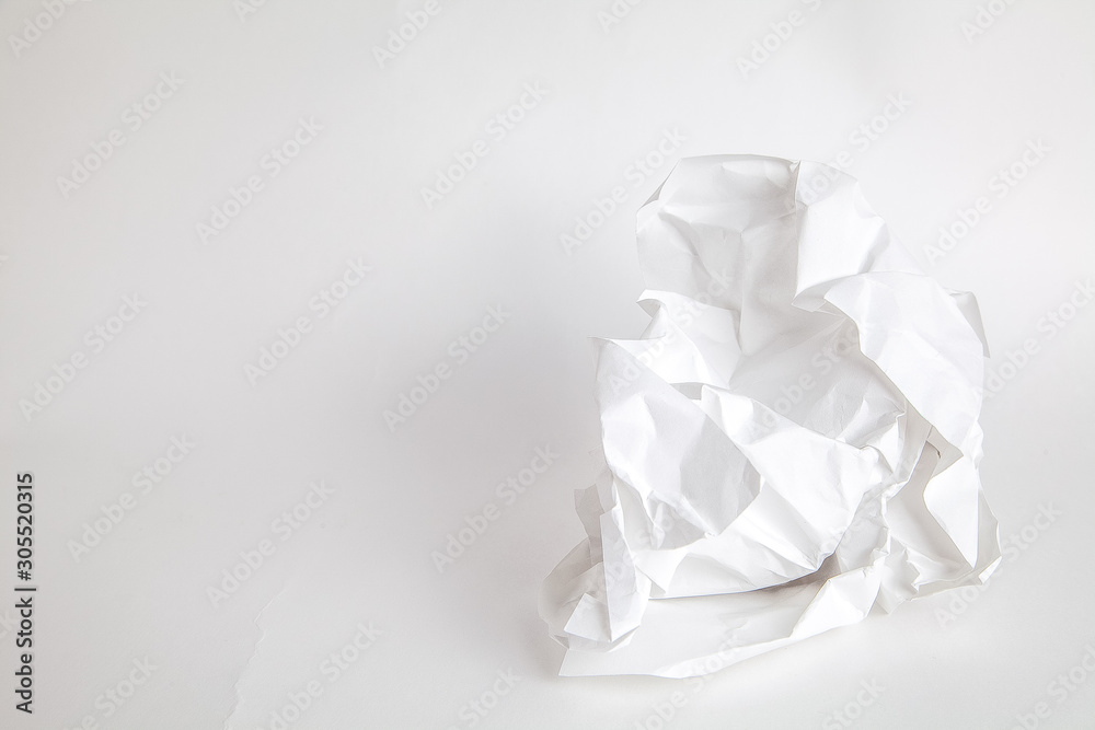 crumpled white paper on a white background, a sheet of paper on a white surface