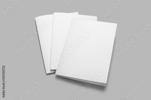 Three white folded pieces of paper on gray background