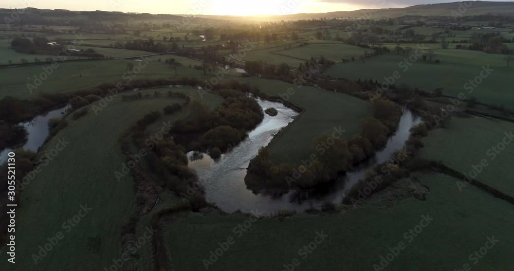 Sunrise over a countryside and a river in north England. Sunrise over a countryside and a river in north England.