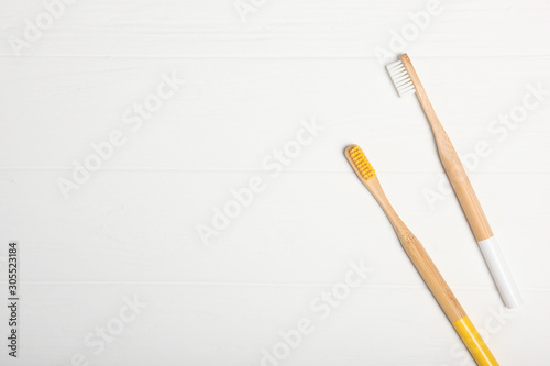 natural bamboo toothbrushes on a light background top view. Oral and dental care.
