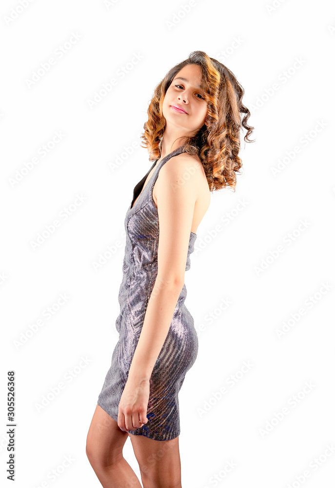 elegant girl in a shiny dress stands in the Studio. Isolated on a white background. Side view.