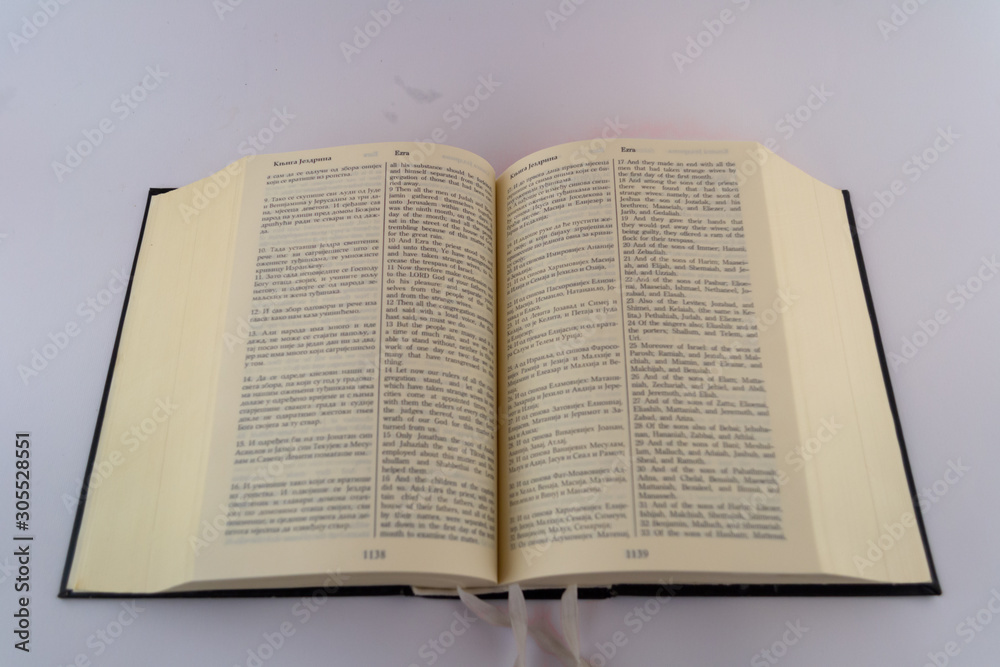 Books and pages against white background. Holly Bible and Davids psalms. Close up words and letters Books and pages against white background. Holly Bible and Davids psalms. Close up words and letters