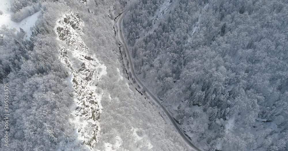 Aerial view of snow covered sunlit cliffs in the forest. Nature in winter time Aerial view of snow covered sunlit cliffs in the forest. Nature in winter time