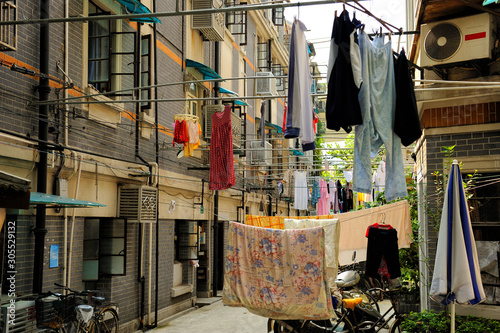 Photography Washed clothes drying outdoor in old street in Shanghai, China.