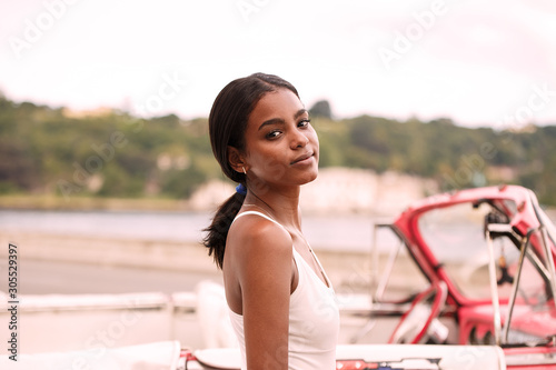 young cuban and pink almendron , havana photo