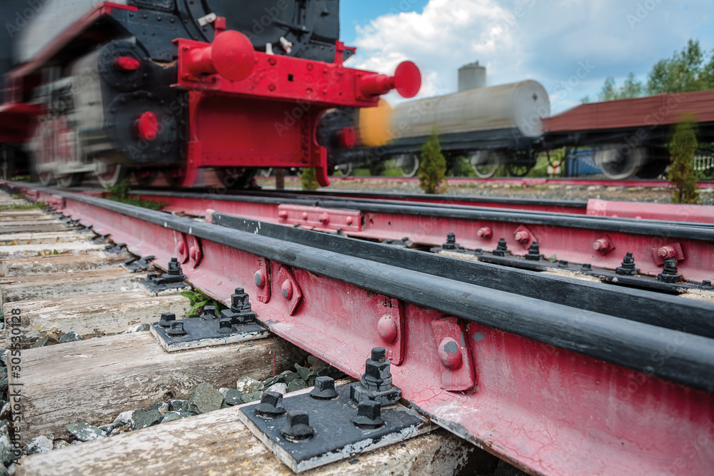 rails for trains close-up selective focus, against the background of the train coming towards, safety on the railway, the danger of railway crossings, selective focus rails for trains close-up selective focus, against the background of the train coming towards, safety on the railway, the danger of railway crossings, selective focus