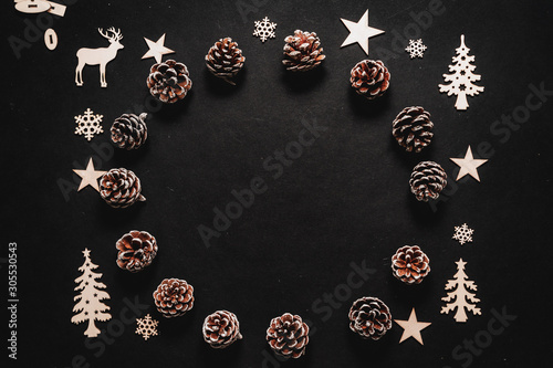 wooden winter elements, snowflakes, trees, pine cone and reindeer isolated on black background, beautiful christmas decoration