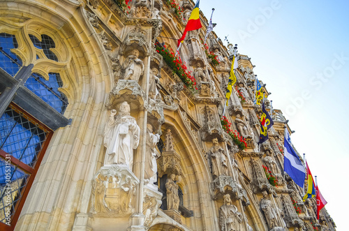 Beautiful Emblematic Building of the City Hall of Leuven with Statues and Flags (Old Church)