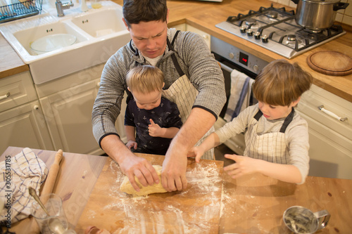 Dad and sons make cookies