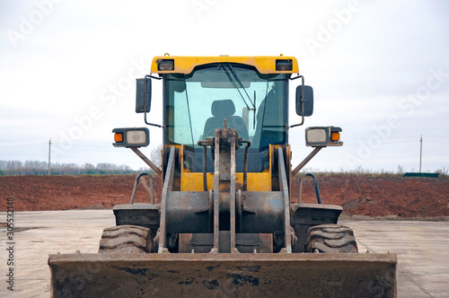 Front-end loader at a construction site. Big loader close-up.