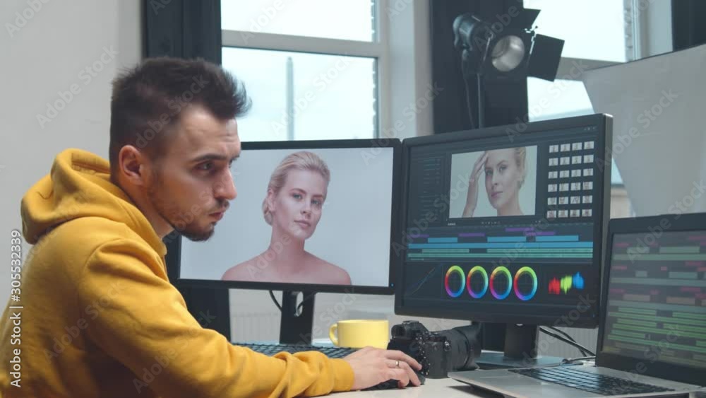 Freelance videographer colorist editing footage using professional