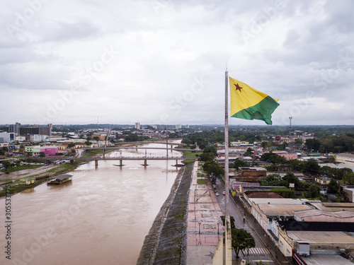 Aerial drone view of Acre river and flag in the amazon. Rio Branco city center buildings, houses, streets, bridges on cloudy day. Brazil. Concept of environment, ecology, climate change and travel. photo