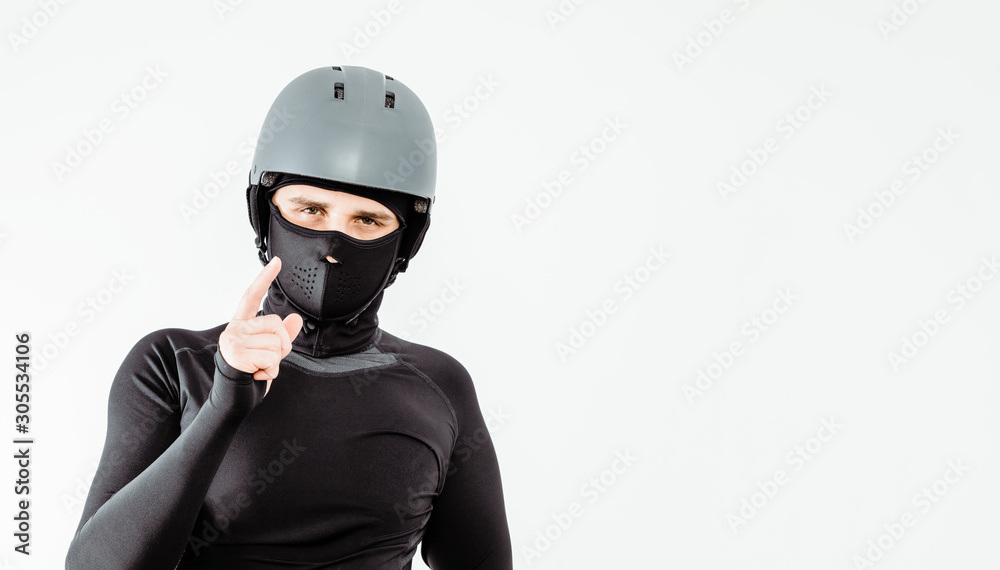 An athlete wearing a sweatshirt and helmet prepares for sport. The concept of playing sports, extreme sport. Putting on the necessary protective clothing. An athlete wearing a sweatshirt and helmet prepares for sport. The concept of playing sports, extreme sport. Putting on the necessary protective clothing.