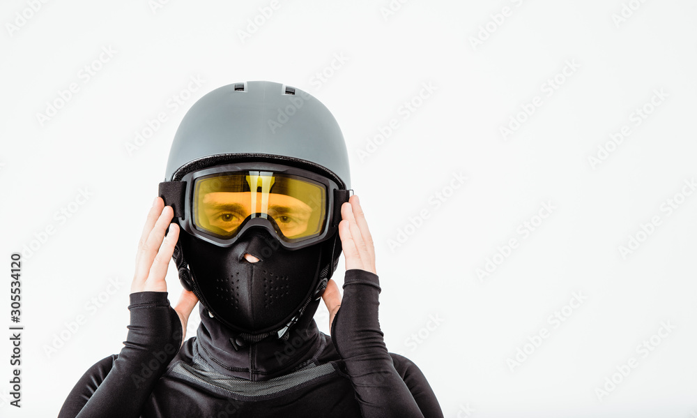 An athlete wearing a sweatshirt and helmet puts on Google. The concept of practicing extreme sports. Appropriate preparation and clothing for sports.