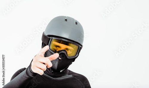 An athlete wearing a sweatshirt and helmet prepares for sport. The concept of playing sports, extreme sport. Putting on the necessary protective clothing. © Sebastian