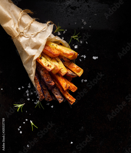 French fries,  baked fries from different types and colors of potatoes sprink...