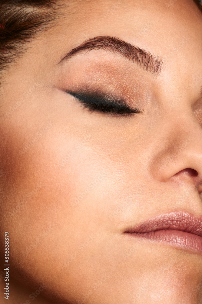 Close up shot of a woman face with beauty make up.