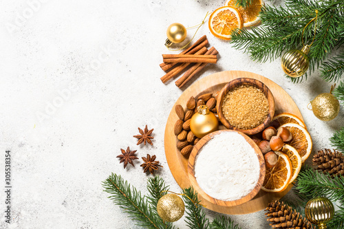 Christmas baking background with spices on white.