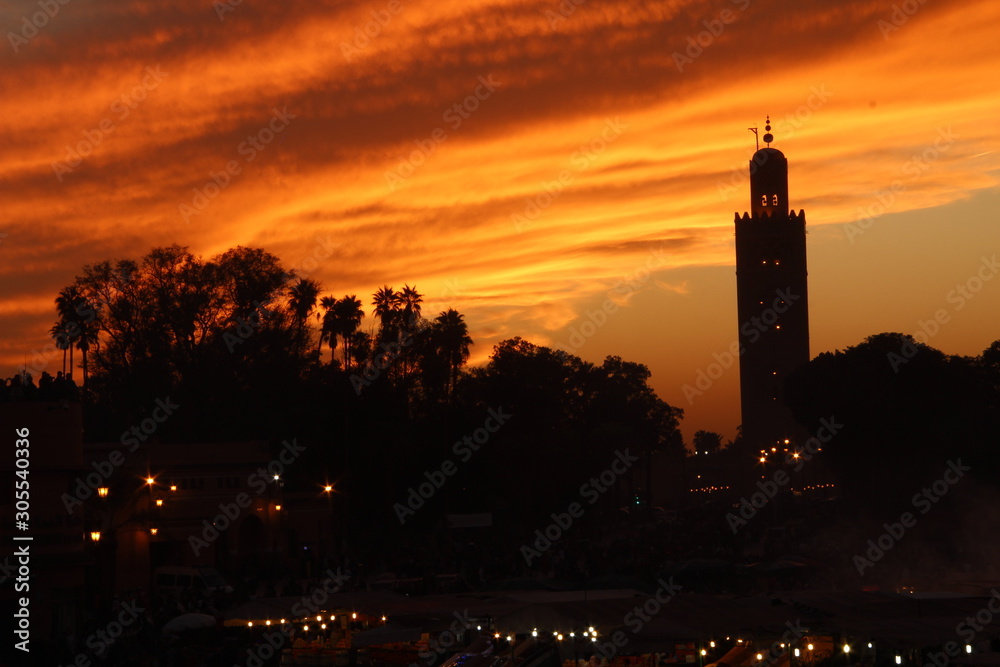 Sunset of the illuminated night market in Marrakech square