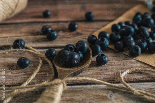 Tasty bilberry on wooden surface