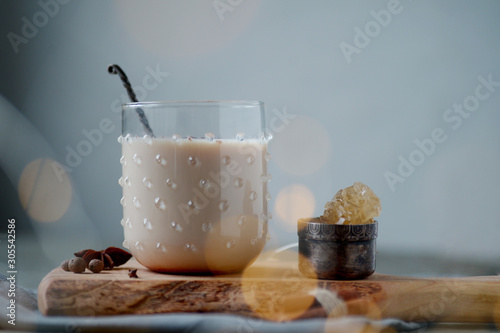 Indian masala chai tea, spiced tea with milk on rustic wooden desk, selective focus, copy space photo