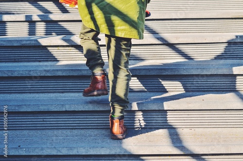 feet of people walking on street photo