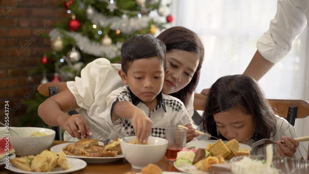happy asian family tradition having lunch together on christmas day at home happy asian family tradition having lunch together on christmas day at home