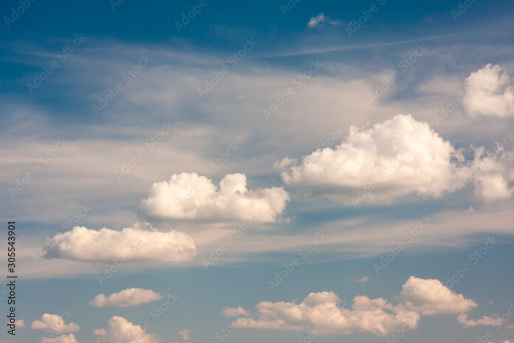 Cumulus clouds gently moving across the summer blue sky Cumulus clouds gently moving across the summer blue sky