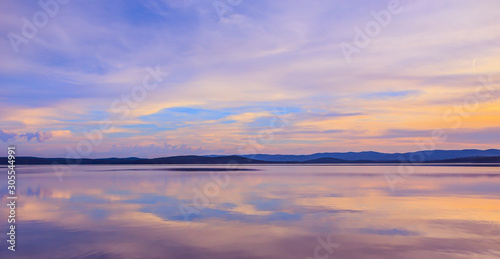 Beautiful clouds reflected on the surface of the lake © Yuri Bizgaimer