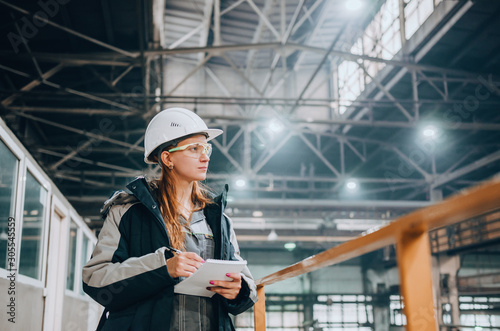 Young female engineer of large industrial plant
