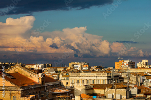 storm clouds in the distance above the roofs of houses in Sicily, Italy © stefano