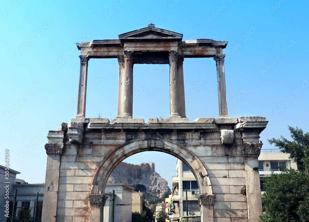 Arch of Hadrian in Athens.  Most commonly known in Greek as Hadrian's Gate. A Roman triumphal arch. Acropolis in the background.