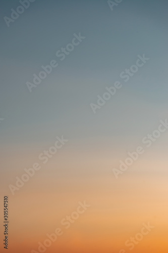 Beautiful clear, morning sky at sunrise, natural background. Soft gradient from orange to blue.