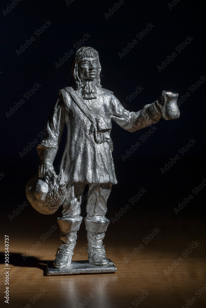 Musketeer made in white metal holding a tankard and hat male figure standing